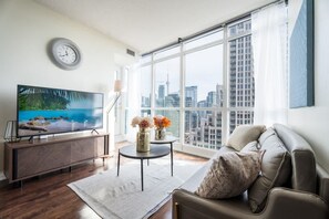 Unwind in style with cozy seating designed for ultimate relaxation after a day in the city. - Chic 2BR+D Condo w/Lake & CN Tower Views + Parking (Toronto)