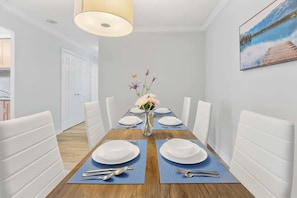 Gather around the spacious dining table, ideal for meals, remote work, or late-night chats. - Downtown 3BR Condo w/Parking, Walk to Hotspots (Toronto)