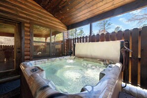 A hot tub in a wooden cabin with a wooden deck and a wooden fence. - Twisted Mane - Prime Location - Family Friendly (Broken Bow)