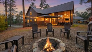 A log cabin with a fire pit, outdoor seating, and a covered patio area. - Twisted Mane - Prime Location - Family Friendly (Broken Bow)