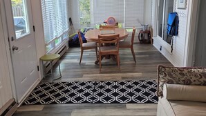 A room with a ceiling fan, a dining table with chairs, a patterned rug, and a sofa. - Lake front cottage with private dock
4 Bedroom  2 bathroom (Innisfil)