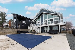 A modern two-story house with a covered patio area. - Family Lakefront Getaway - Pool - Hot Tub (Antioch)