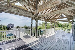 A wooden deck with a white railing, a sign indicating it's a private boardwalk for owners and guests, and a view of the ocean. - Emil Cottage- Luxary 4-bedroom in Coast Cottages  was featured on HGTV (St. Simons Island)
