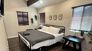 A bedroom with a bed, bedside tables, and a window with blinds. - 3-bedroom cabin in amazing Running Springs with cozy vibes (Running Springs)