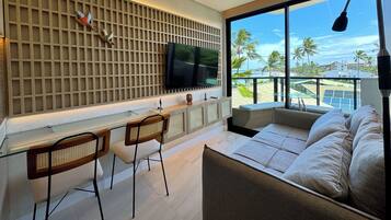 Departamento Deluxe, vista al mar | Área de sala de estar