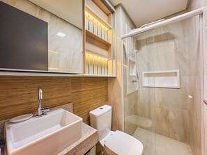 Apartamento luxo | Banheiro | Chuveiro, secador de cabelo, toalhas de banho, papel higiênico