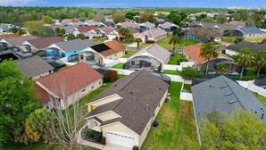 A residential neighborhood with houses featuring various roof styles and some with attached garages. - Indian Creek Beautiful 4 Bedroom 3 Bathroom Villa Close to Disney (Kissimmee)