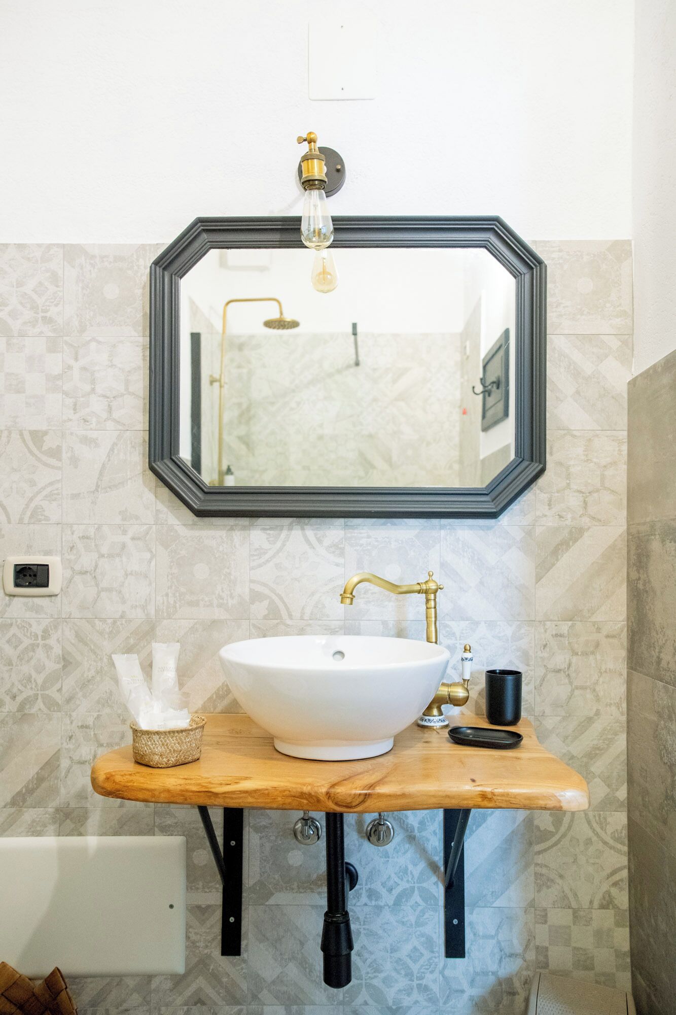 Un baño con lavamanos blanco, un espejo y una ducha.