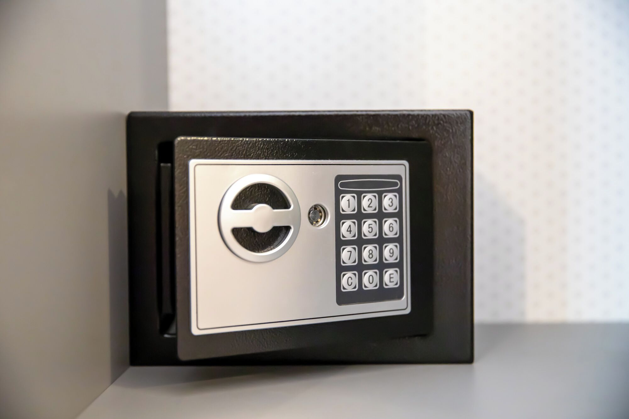 A safe with a keypad and a lock symbol.