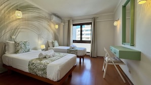 A hotel room with two beds, a desk, a mirror, and a view of the outside. - Vilamoura Charming 2 With Pool by Homing (Loulé)