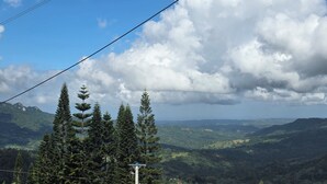 A mountainous landscape with dense forests, power lines, and a clear sky. - Spacious 5-bedroom villa/AC at beach resort
15 restaurants/bars. 
All Inclusive! (Cofresi)
