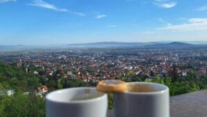 A cityscape with a clear sky and a mug in the foreground. - BELLESTAY/Suite for 4 (Brașov)