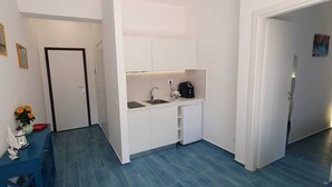 A compact kitchen with a sink, a coffee maker, and a small refrigerator. - B&B VISTAMARE - (SEA VIEW) 250 meters from the center (San Nicola Arcella)
