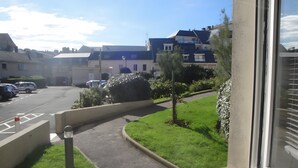 A residential street with houses, parked cars, and a grassy area. - 3* Gîte: Port & Beach, 50m from the Sea, South-Facing, Quiet Location (Fécamp)
