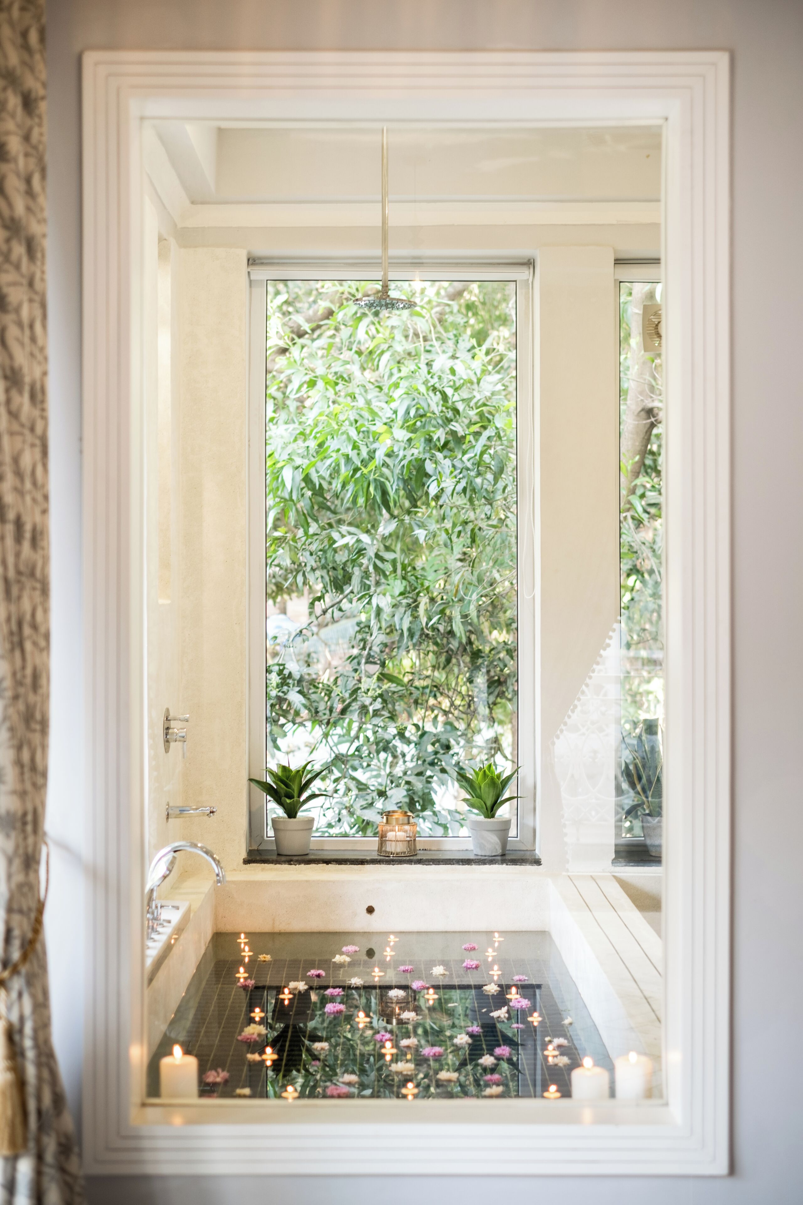 Ein Badezimmer mit Fenster, Badewanne und Waschbecken.