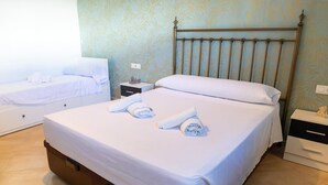 A hotel room with two beds, a metal headboard, a nightstand, and a drawer unit. - Modern Holiday Home in Almeria With Pool (Pechina)