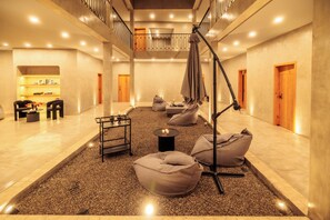 A spacious indoor area with a mezzanine level, bean bags, a standing lamp, and a small table with candles. - Casa Rosario Bed & City Oaxaca (Oaxaca)