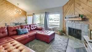 A living room with a sectional sofa, a fireplace, and a view of the outdoors. - Near Hiking! Family-friendly Pagosa Springs Haven (Pagosa Springs)