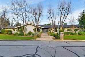 A residential house with a front yard, a driveway, and a mailbox.