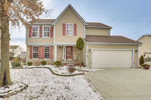 A two-story house with a garage, a stone foundation, and a snow-covered lawn. - 6 Mi to Rickenbacker Airport! Columbus Area Home (Groveport)