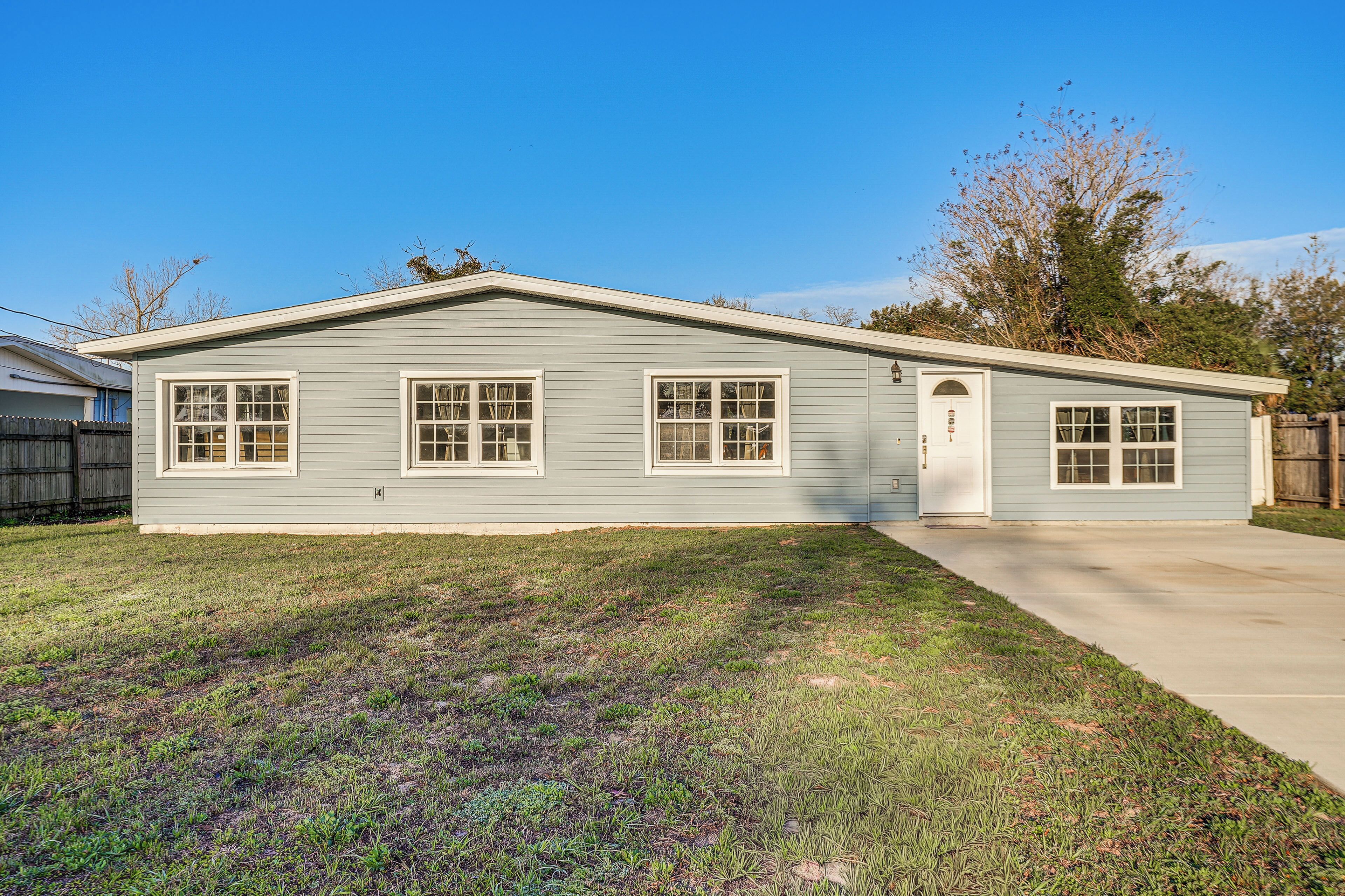 A single-story house with a front porch, a garage, and a well-maintained lawn.