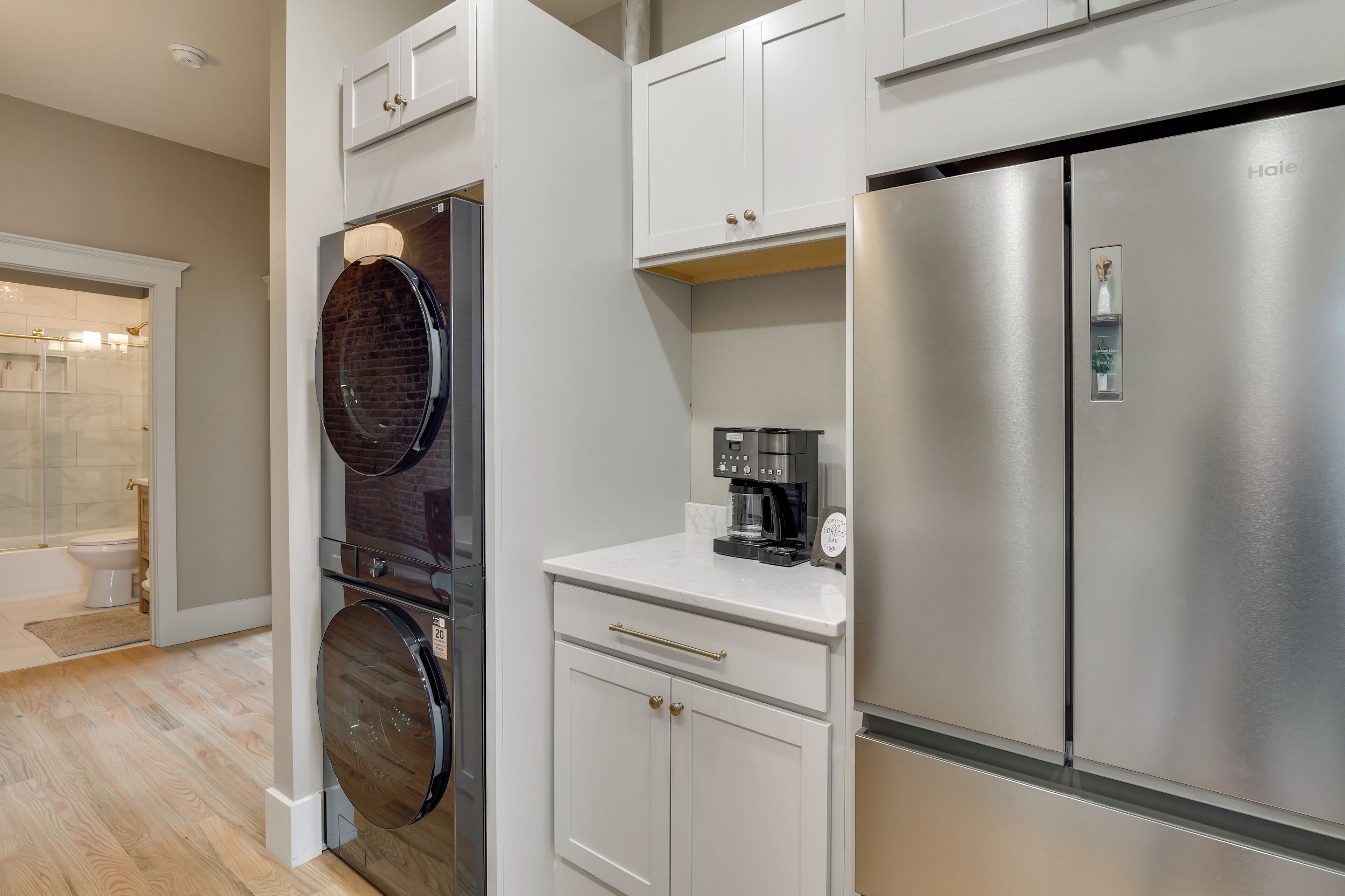 A modern kitchen with stainless steel appliances, a built-in oven, and a coffee maker.