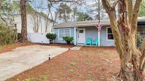 A residential property with a front yard, a mailbox, and a small porch with two chairs. - Fun in the Sun w/ Family - Pensacola Duplex + Yard (Pensacola)