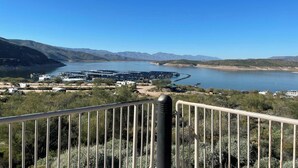 A coastal landscape with a marina, hills, and sparse vegetation.