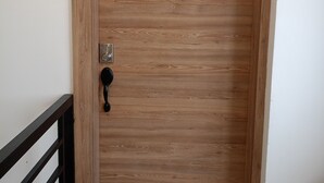A wooden door with a number '5' and a keypad lock. - Charming 2-bedroom apartment with AC in sunny Playas (Playas)