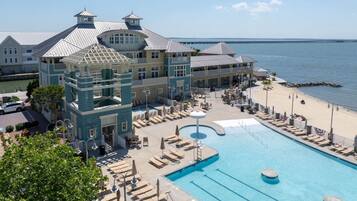 A resort with a large pool, beach access, and a view of the ocean.