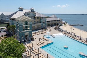 A resort with a large pool, beach access, and a view of the ocean.