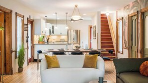 Ein modernes Wohnzimmer mit einer Couch, einem Couchtisch und einem Essbereich mit Tisch und Stühlen.