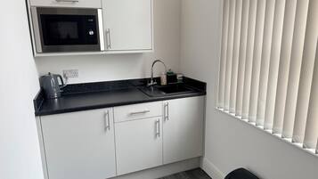 Fridge, microwave, cookware/dishes/utensils