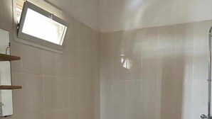 A bathroom with a toilet, sink, and shower. - Jozene House  (Ngaparou)