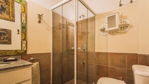 A bathroom with a glass-enclosed shower, a toilet, and a sink with a towel hanging on the wall. - Sky Garden [Art Nouveau] Wild Terrace & Mini Pool (Montevideo)