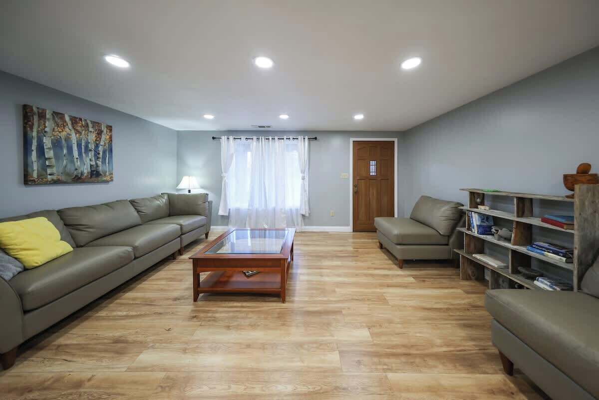 A living room with a sofa, a coffee table, and a bookshelf.