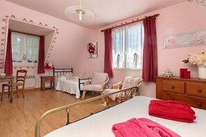 A room with a bed, a desk, a chair, a small table, and a window with curtains. - Rose Briéronne Guest Room 3p – Upstairs, Shared Terrace & Garden, Wi-Fi (Saint-Lyphard)