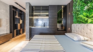 A modern bedroom with a bed, a large window, a built-in wardrobe, and a green wall. - Vista Mare Horizon | Patio with Amazing Seaview by PikHost (Vlorë)