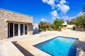 A stone building with a pool, a patio, and a clear blue sky. - Villa Omega - Two Bedroom Villa, Sleeps 4 (Ditiki Mani)