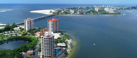 A coastal hotel with multiple high-rise buildings, a marina, and a beach area.