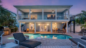 A two-story house with a swimming pool, outdoor seating, and a covered patio. - 218 Dolphin Beach House (Fort Myers Beach)