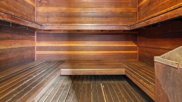 A sauna with wooden walls and benches.