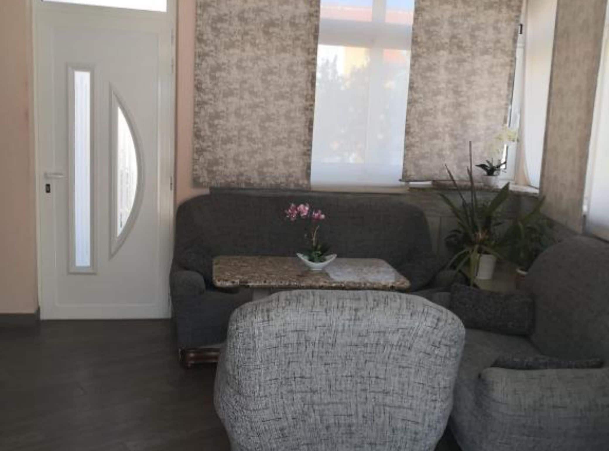 Apartment (Apt 1) One-Bedroom Apartment with Ter) | Living room | 32-inch flat-screen TV with digital channels