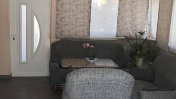 Apartment (Apt 1) One-Bedroom Apartment with Ter) | Living room | 32-inch flat-screen TV with digital channels