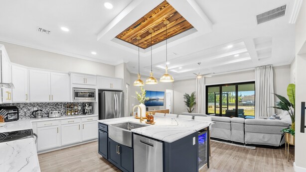 A modern kitchen with a central island, stainless steel appliances, and pendant lighting. - Family-Friendly Palm Bay Getaway! 20 Mi to Beaches (Palm Bay)