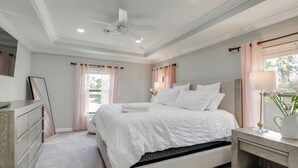A bedroom with a bed, bedside table, dresser, ceiling fan, and window with curtains. - Family-Friendly Palm Bay Getaway! 20 Mi to Beaches (Palm Bay)
