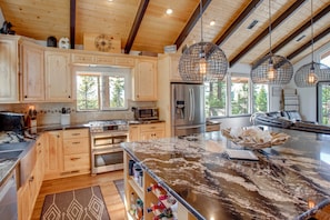 A spacious kitchen with wooden cabinets, stainless steel appliances, and a large island. - Walk to Heavenly Lifts! Spacious Family Retreat (South Lake Tahoe)