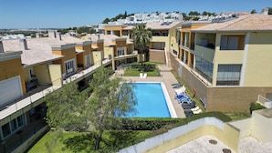 A residential building with a swimming pool, balconies, and a view of the city. - #356 Vale de Parra | Pool & Nature (Albufeira)