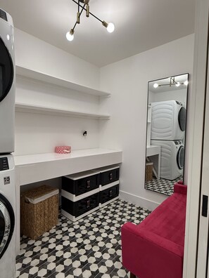A laundry room with a washing machine, dryer, shelves, a mirror, and a checkered floor. - The Eagle's Nest - 1 Min ATV Trail Access (Jacksboro)