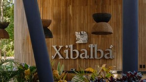 A wooden wall with the sign 'Xibalba' and a stylized bird design. - New Studio @ Xibalba | Private Pool + King Bed (Tulum)
